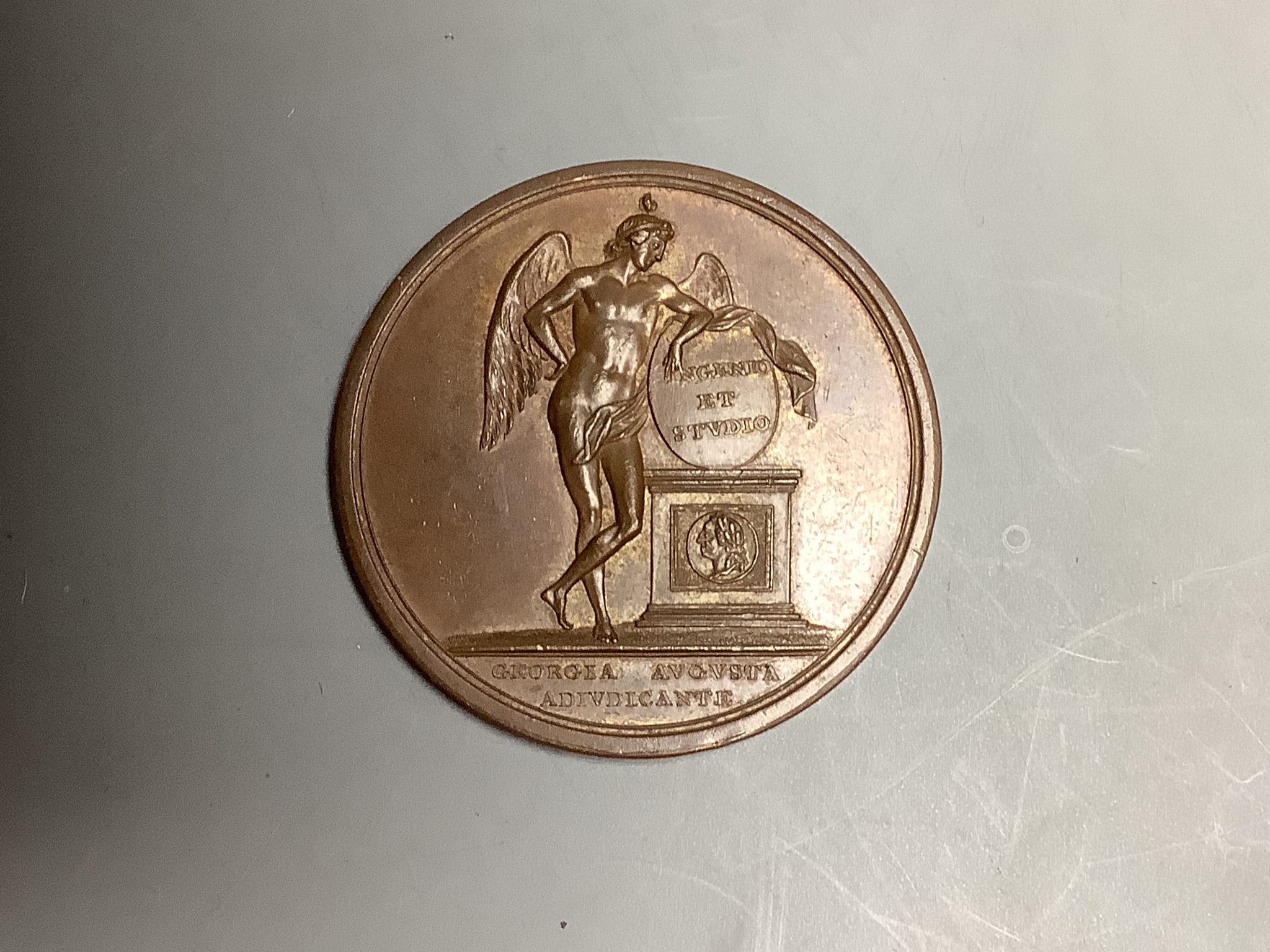 German medals, Göttingen University bronze Prize Medal, 1785, 50mm, by Edward Burch RA. Laureate bust r. R/ Winged Genius leaning on monument, inscribed INGENIO ET STVDIO above medallic portrait of George III, in exergue